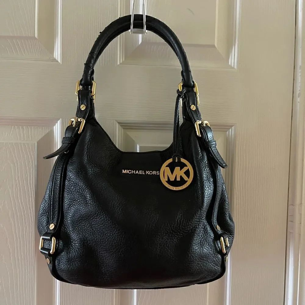 Michael Kors Black Pebble Leather Satchel with gold tone hardwares and accents.